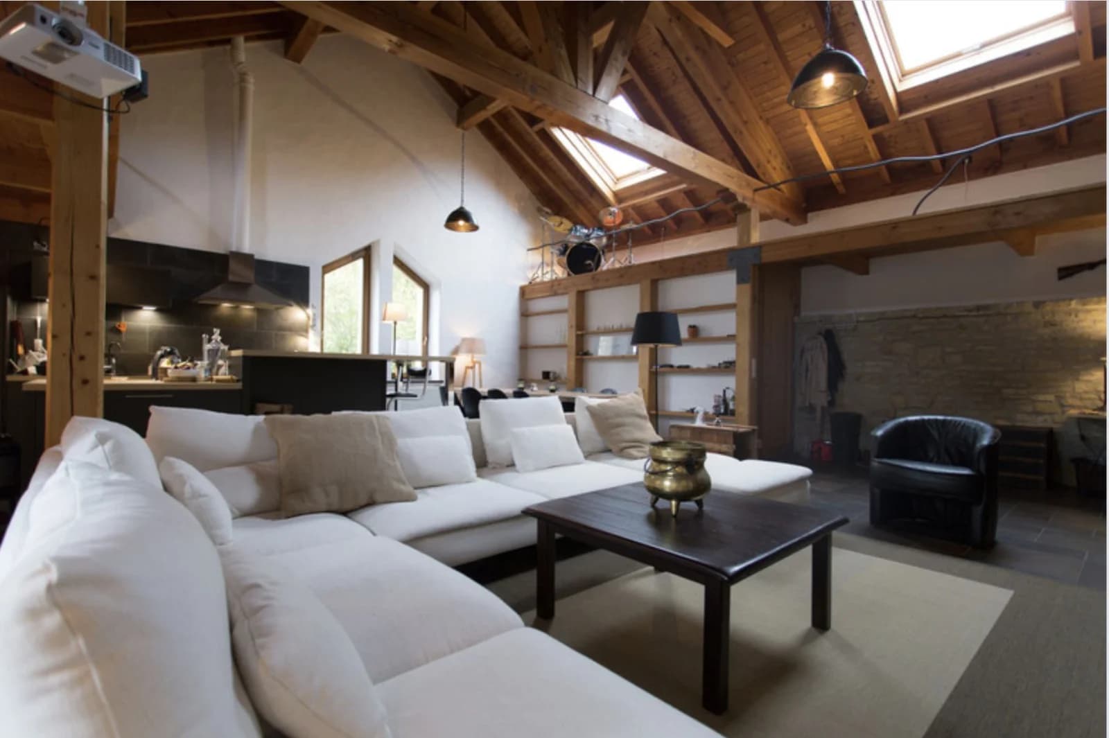 Living room in Large loft with exposed beams and stonework - 1